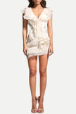 FJØRNA asymmetric ruffled women's mini dress featuring a stylish design, perfect for party and day wear, shown on a model.