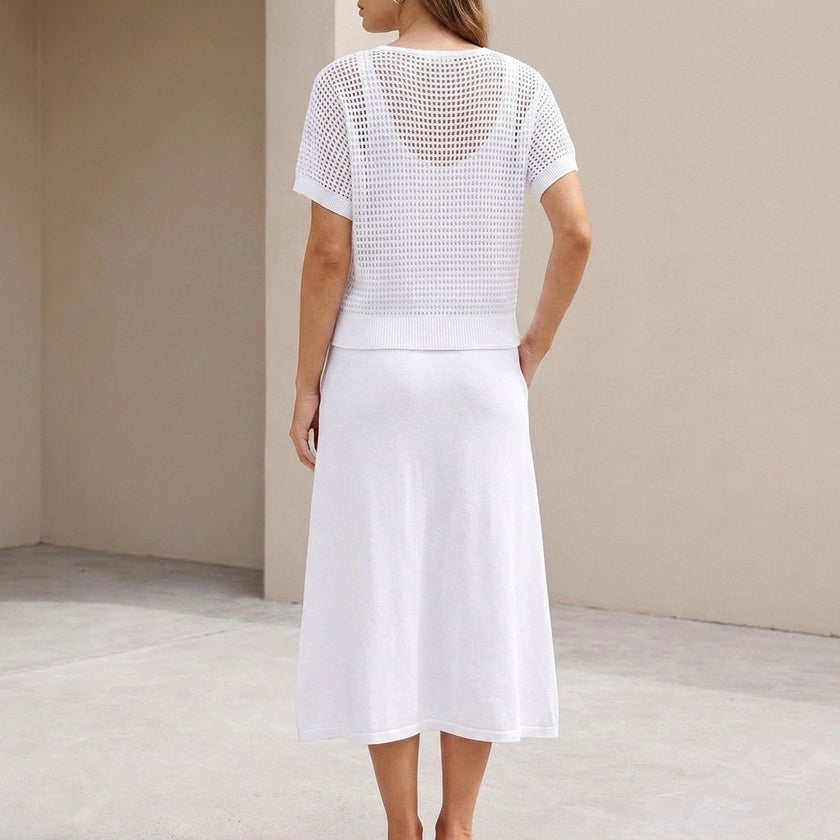 FJØRNA flowing midi dress and cropped open-knit mesh top set, back view showing the elegant drape and textured fabric details.