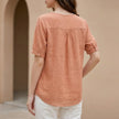 FJØRNA women's summer floral linen blouse with V-neck, back detail, casual style, laid flat showing fabric and design features.