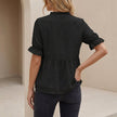 Back view of FJØRNA women's relaxed peplum blouse with ruffled V-neck and tiered hem, showcasing feminine detailing.
