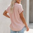 FJØRNA women's collared button-up blouse with cuffed sleeves and chest pocket, shown from the back with detailed cuff and seam work.