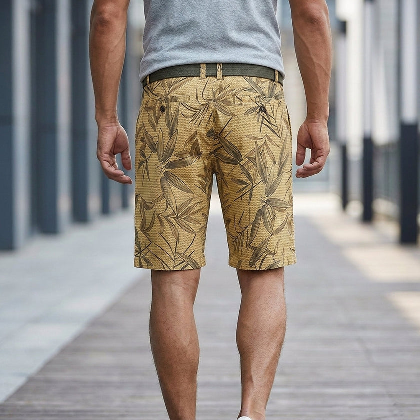 Men's casual work shorts with leaf print and belt, showing back detail and relaxed fit, by FJØRNA.