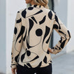 Back view of FJØRNA relaxed print blouse for women featuring a shirt collar and abstract pattern.