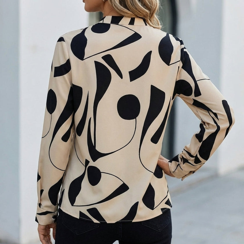 Back view of FJØRNA relaxed print blouse for women featuring a shirt collar and abstract pattern.