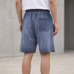 FJØRNA men's casual knit shorts with distressed finish, raw hem, and relaxed fit, shown from the back.