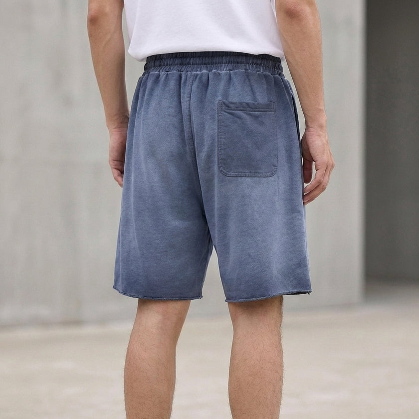 FJØRNA men's casual knit shorts with distressed finish, raw hem, and relaxed fit, shown from the back.
