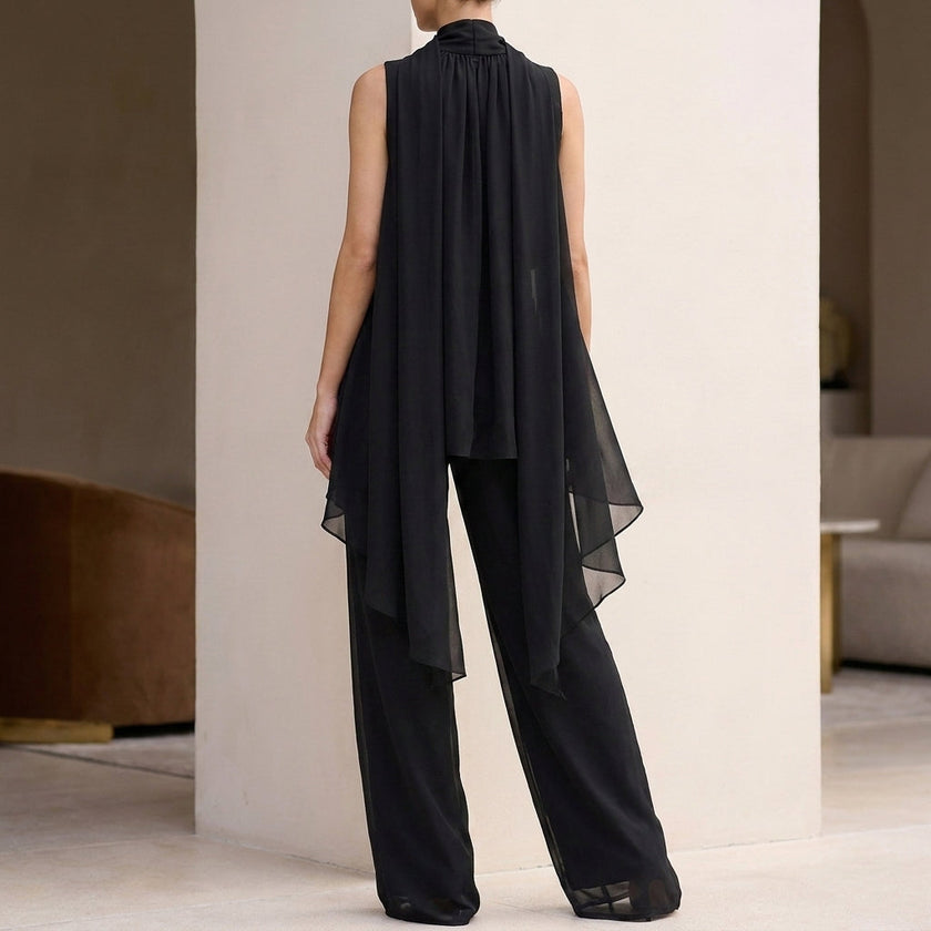 Back view of FJØRNA elegant two-piece chiffon pleated women's co-ord set, showcasing the flowing fabric and pleated design.