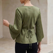 Back view of FJØRNA women’s summer satin blouse with V-neck and high waist, showcasing smooth fabric and stylish fit.