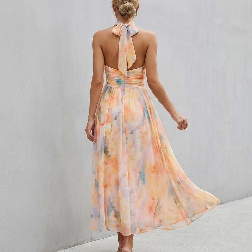 FJØRNA pleated belted A-line halter neck maxi dress showing back details and flowing fabric for women.