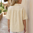 FJØRNA women's floral short sleeve denim summer blouse, back view showing lightweight fabric and stylish design.