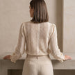 FJØRNA women's summer blouse with V-neck, long sleeves, and lace detailing, shown from the back.