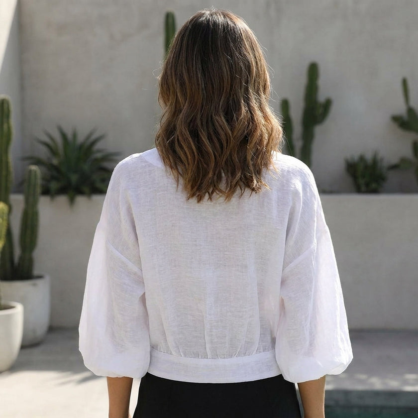 FJØRNA women's summer blouse with V-neck and high waist, back view showcasing lightweight fabric and stylish fit.
