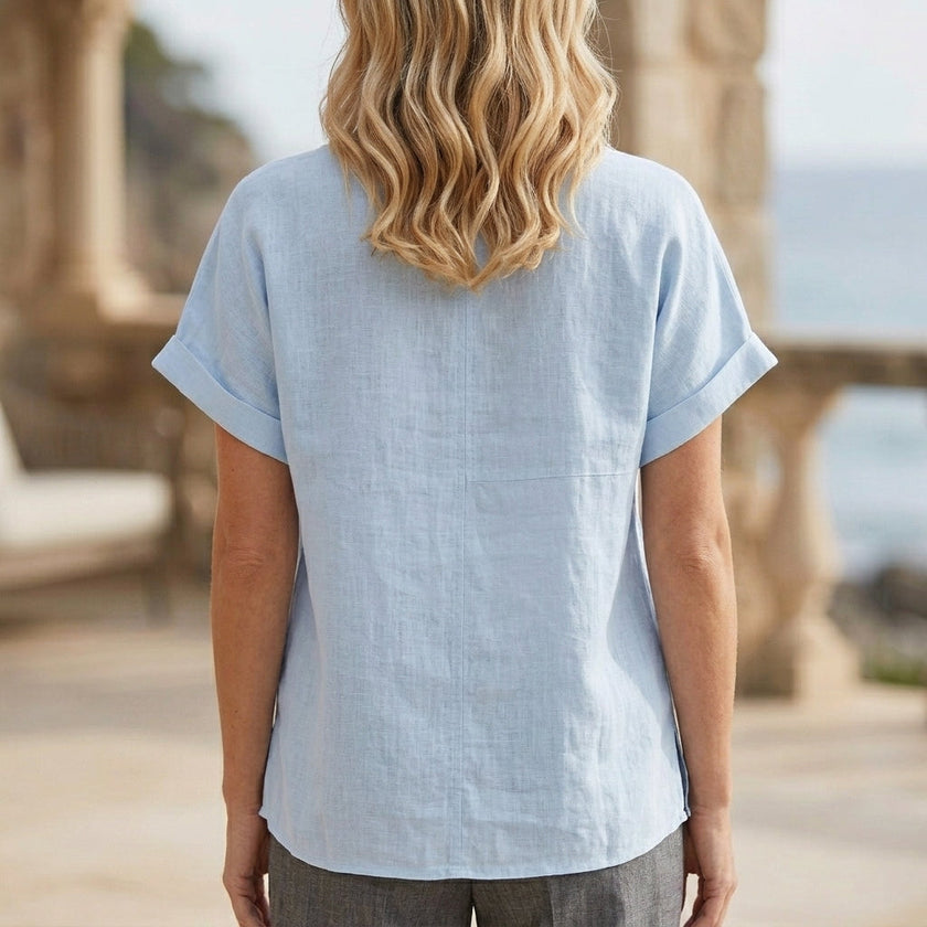 FJØRNA women's summer V-neck short sleeve denim blouse shown from the back, casual and stylish for warm weather.