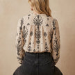 FJØRNA women's summer blouse with print and V-neck, showing the back view of the stylish, lightweight top.