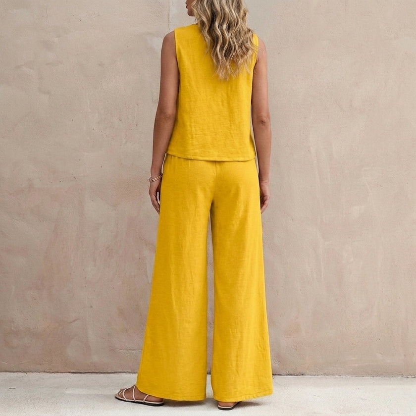 FJØRNA sunlit sleeveless two-piece set with flowing wide-leg pants, shown from the back on a model.