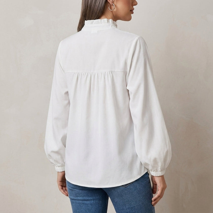 FJØRNA women's summer blouse with V-neck, puff sleeves, and ruffle details, shown from the back in a stylish women's top.