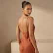 FJØRNA satin fitted maxi dress with cowl neck and spaghetti straps, shown from the back for elegant evening wear.