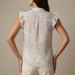 FJØRNA women's floral sleeveless summer blouse shown from the back, lightweight top with a relaxed fit and floral print.
