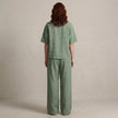 FJØRNA zip-neck top and wide-leg trouser set, back view showcasing the sleek design and comfortable fit of the 2-piece outfit.