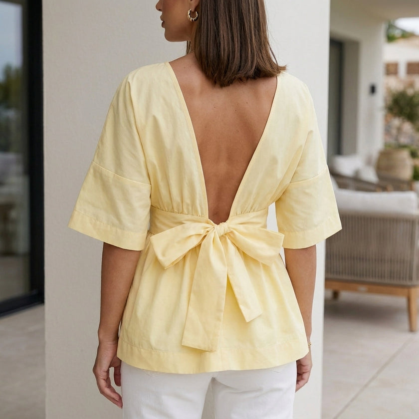 Back view of a women's linen summer blouse by FJØRNA, featuring a flowy, casual design in soft, breathable fabric.