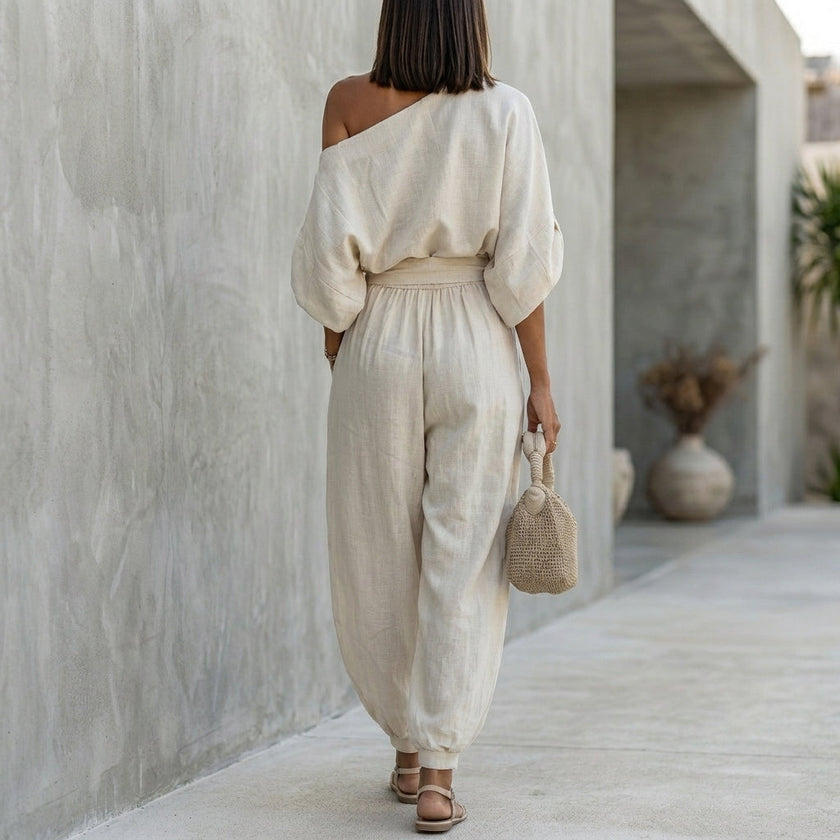 FJØRNA draped one-shoulder top and voluminous lantern pants set, back view showcasing elegant resort chic style.