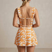 FJØRNA women's summer swimsuit with ruffle floral design, showing the back view of the stylish swimwear.