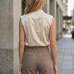 FJØRNA women's high neck sleeveless satin summer blouse shown from the back, featuring a smooth satin fabric and elegant design.