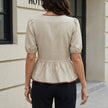 FJØRNA women's summer blouse with puff sleeves in denim, shown from the back with a relaxed fit and stylish design.