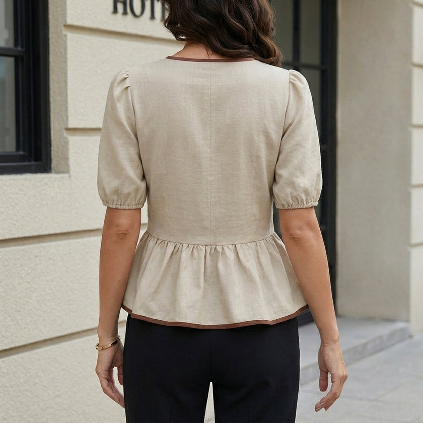 FJØRNA women's summer blouse with puff sleeves in denim, shown from the back with a relaxed fit and stylish design.