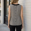 Back view of a women's sleeveless gingham summer blouse by FJØRNA, showcasing a relaxed fit and classic pattern.