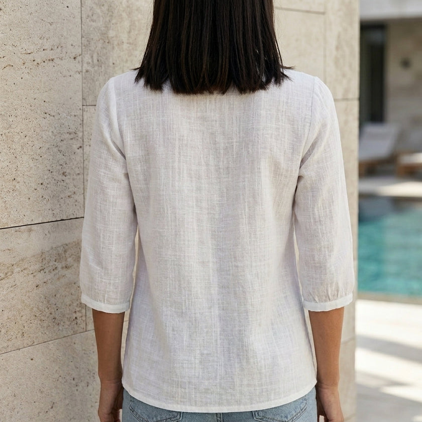 FJØRNA women's summer blouse with square neckline and lace details, shown from the back in a stylish women's top.
