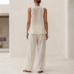 FJØRNA flowing semi-sheer two-piece set with draped wide-leg trousers, shown from the back in a stylish, elegant design.