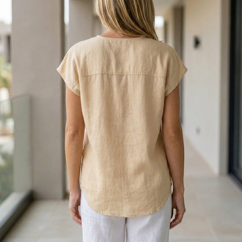 FJØRNA women's summer blouse with V-neck and sleeveless design, shown from the back in a lightweight, stylish top.