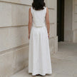 FJØRNA elegant sleeveless crop top and maxi skirt set, back view showcasing flowy fabric and stylish design.