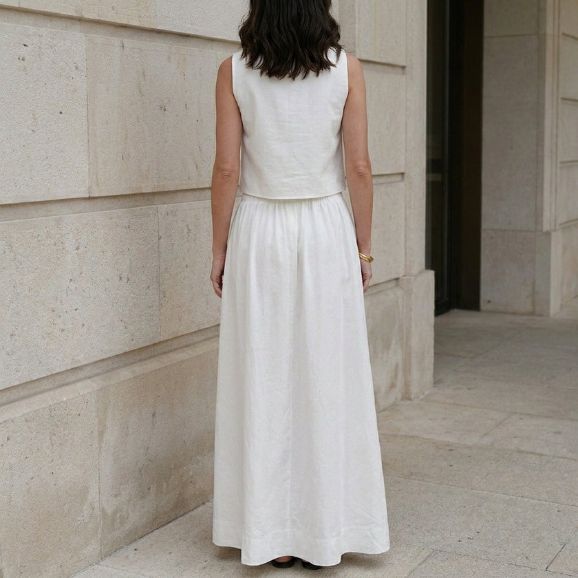 FJØRNA elegant sleeveless crop top and maxi skirt set, back view showcasing flowy fabric and stylish design.