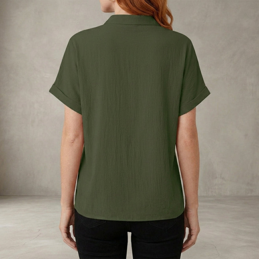 Back view of FJØRNA women's summer V-neck denim blouse with ruffle details, casual and stylish top for warm weather.