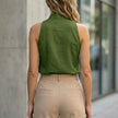 Back view of FJØRNA women's sleeveless denim summer blouse, casual top with classic denim fabric and sleeveless design.