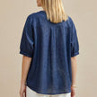 FJØRNA women's summer blouse with V-neck and puff sleeves, shown from the back, in lightweight fabric perfect for warm weather.