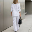 FJØRNA oversized two-piece crinkle-texture suit with relaxed fit and drawstring waist, shown from the back.
