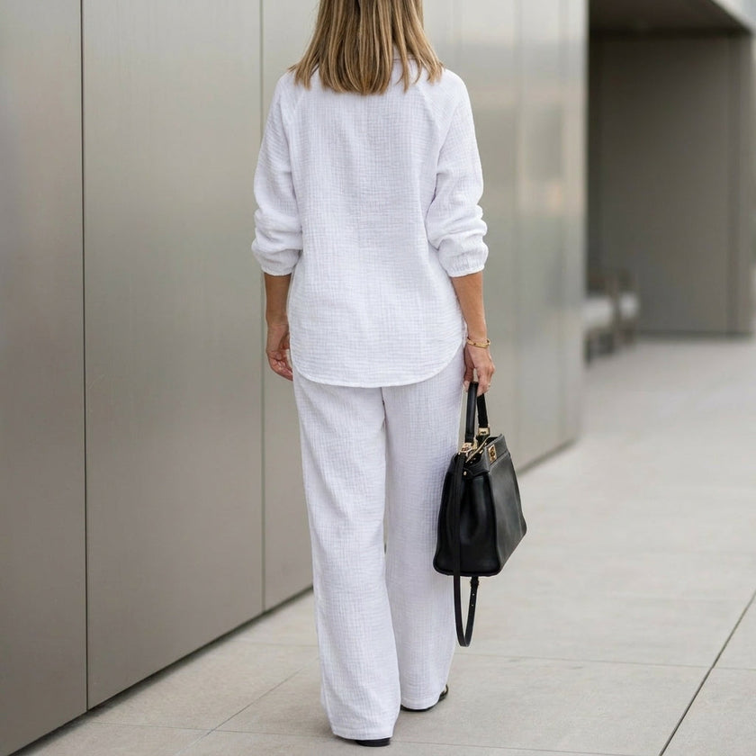 FJØRNA oversized two-piece crinkle-texture suit with relaxed fit and drawstring waist, shown from the back.