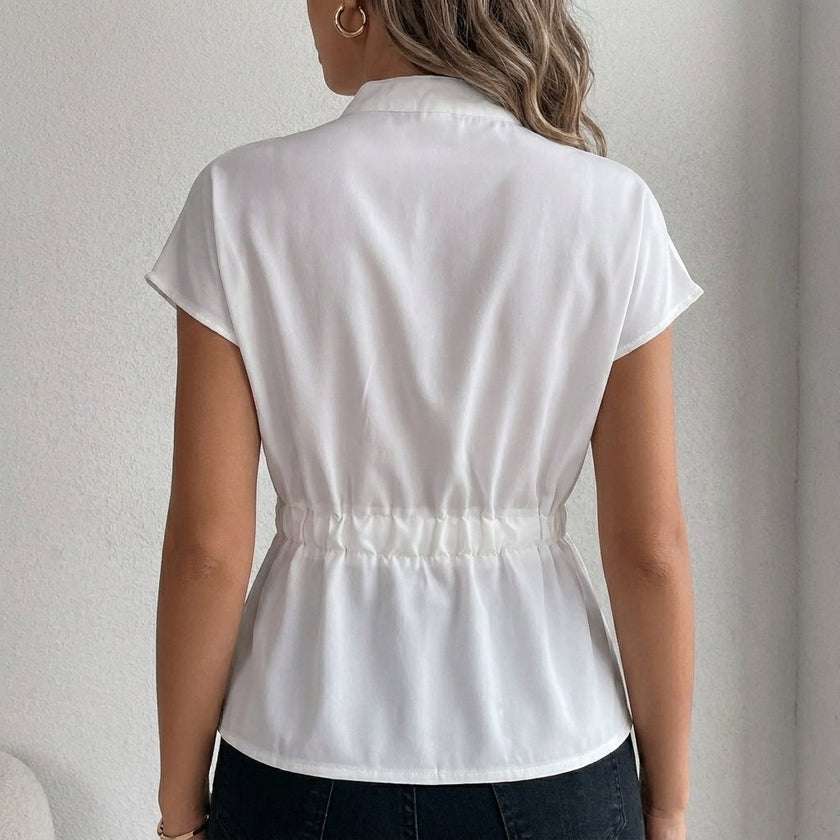 Back view of FJØRNA women's summer cap sleeve denim blouse, showcasing casual style and lightweight fabric.