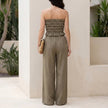FJØRNA smocked strapless top and wide-leg pants resort set shown from the back, featuring a stylish 2-piece ensemble.