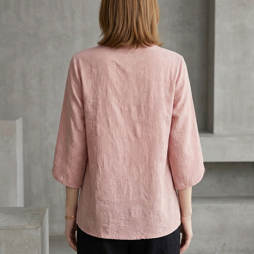 Back view of FJØRNA women's summer denim blouse with tassel details, lightweight and stylish for warm weather wear.
