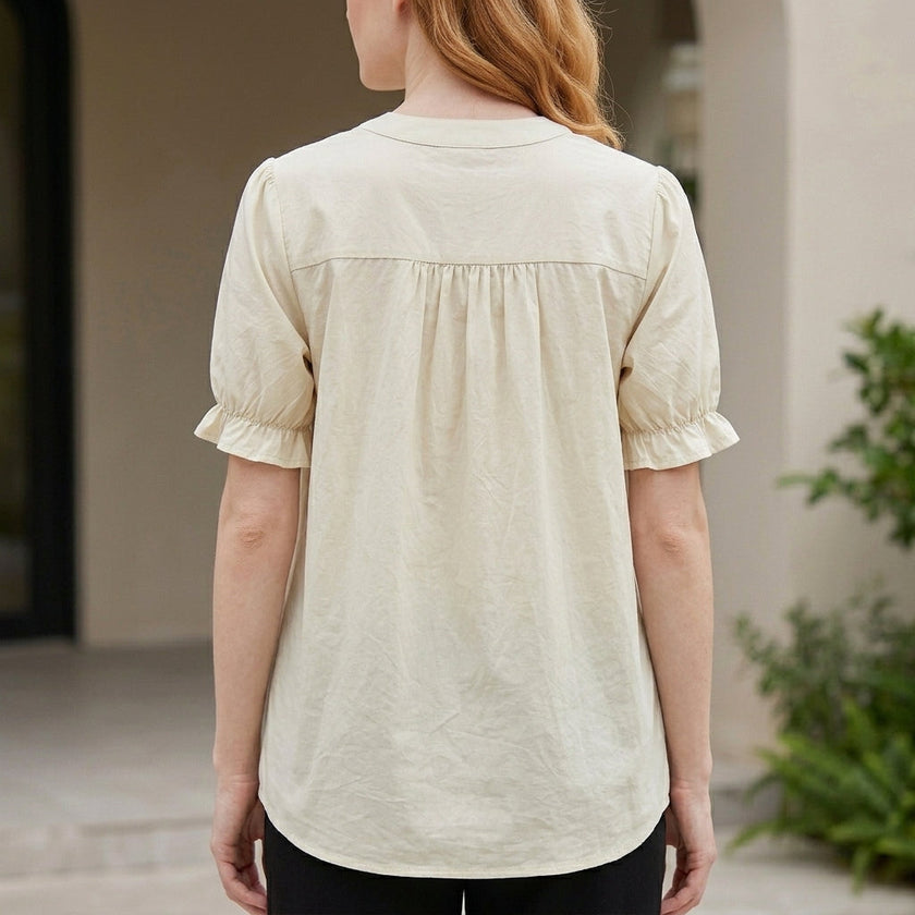 FJØRNA women's summer blouse with puff sleeves, denim fabric, and button front, shown from the back.