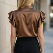 Back view of a FJØRNA summer satin ruffle blouse for women, showcasing its elegant design and lightweight fabric.