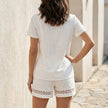 FJØRNA coastal lace trim V-neck top and shorts set, back view showing lace details and relaxed fit in lightweight fabric.