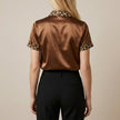 FJØRNA women's leopard print summer blouse with short sleeves, shown from the back in a stylish, lightweight top.