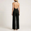 FJØRNA Celeste pleated halter top and wide-leg pant set shown from the back, stylish 2-piece outfit with pleated details and flowy silhouette.