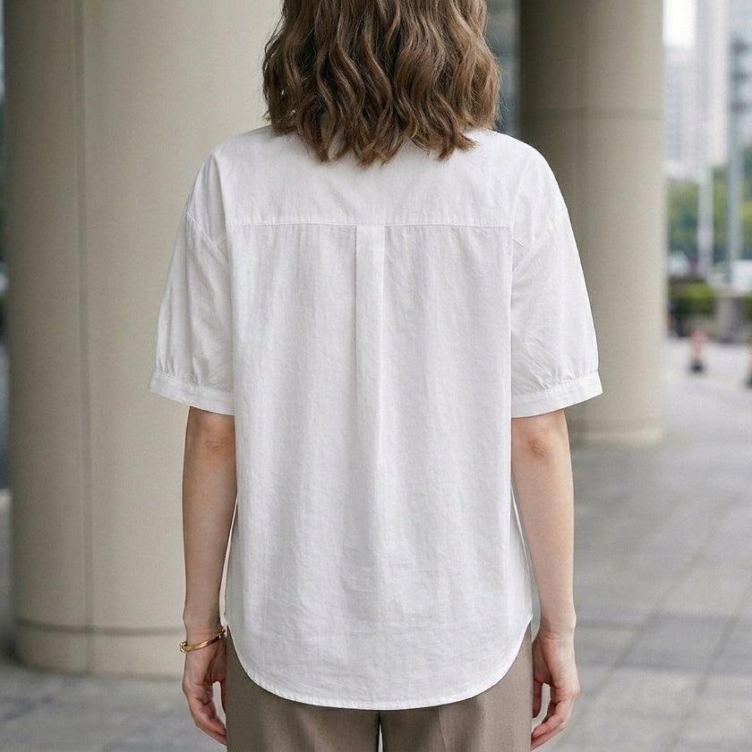 FJØRNA women's summer blouse with puff sleeves, denim fabric, button front, casual style, shown from the back.