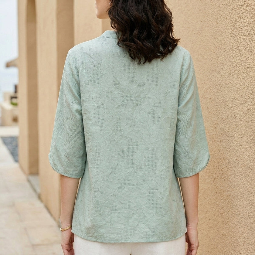 Back view of a flowy denim summer blouse for women by FJØRNA, showcasing relaxed fit and lightweight fabric.